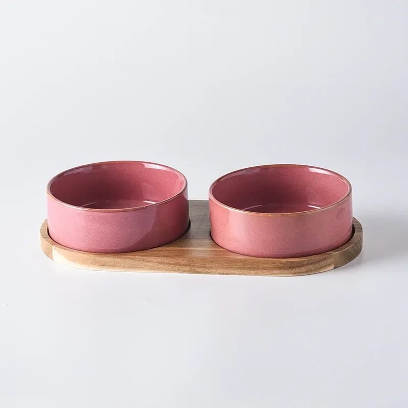 High-angle view of a clean ceramic pet bowl nestled in its durable wooden stand, ready for use.