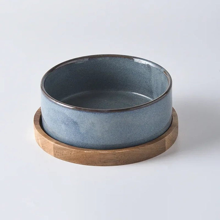 Detailed shot of the smooth ceramic finish of the pet bowl and the grain of the wooden elevated feeder.
