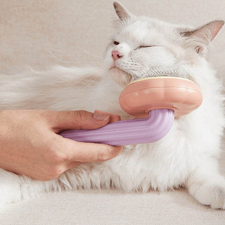 Pet owner using the ergonomic dog and cat grooming brush, demonstrating comfortable grip and easy fur removal.