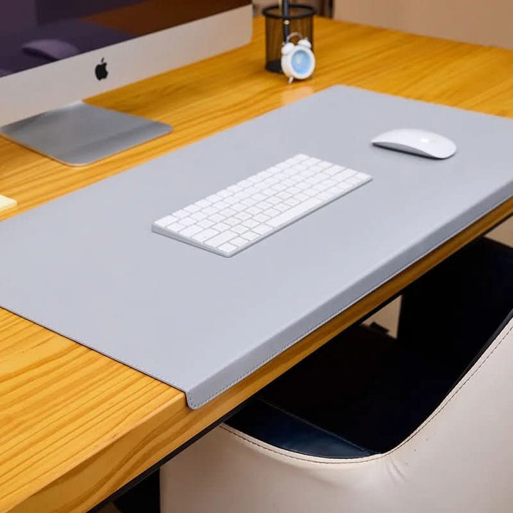 Versatile ergonomic PU leather desk mat with wrist support, great for gaming or professional work.