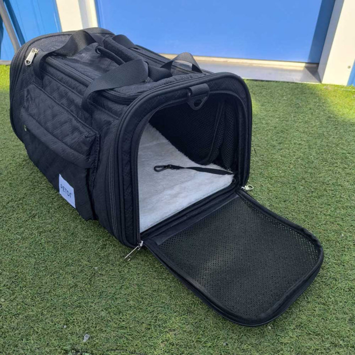Soft-sided pet travel carrier unzipped to show expanded space for cat or small dog
