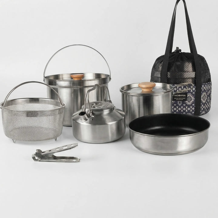 Family using a portable outdoor cookware set to prepare a delicious camp meal at a scenic campsite.