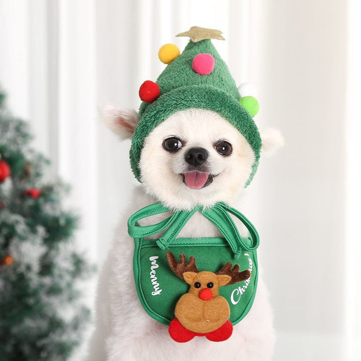 Adorable dog Christmas costume featurng a red hat with pom-pom and white festive bib.