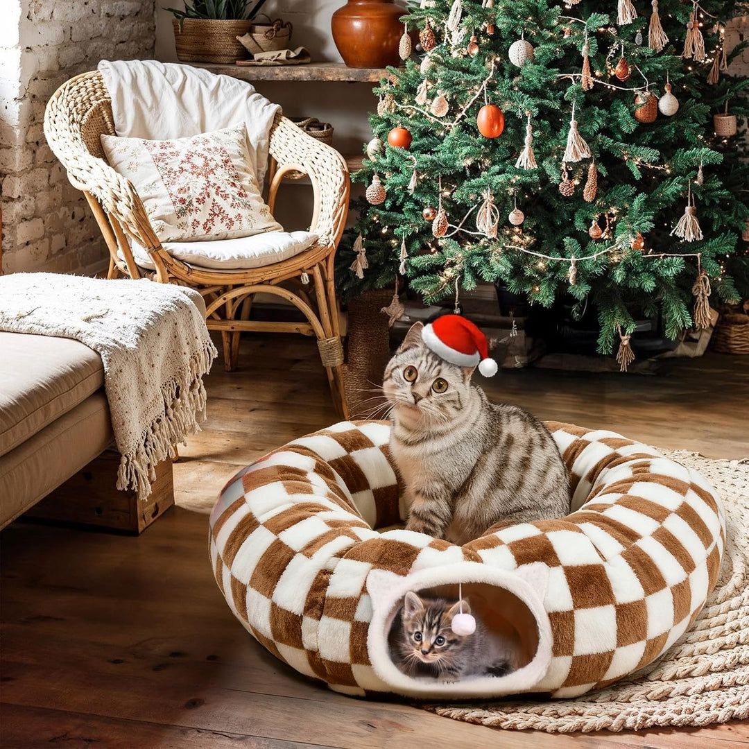Close-up of the plush green fabric of the Christmas Tree Cat Tunnel, featuring embroidered snowflake patterns