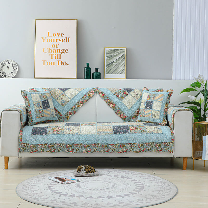 Living room sofa covered with a floral plaid cotton blend couch protector