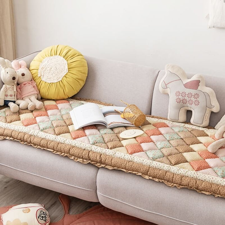 Floral pure cotton sofa cover draped over a couch, showing full coverage and decorative appeal.