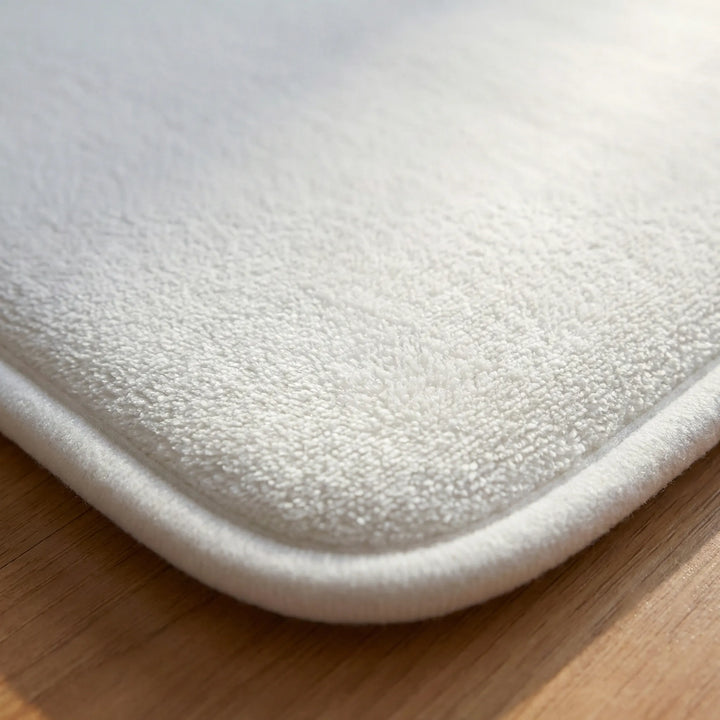 Flowique wave pattern alarm mat, a stylish bedroom rug. Smart pressure sensor ensures non-snooze wake-ups for morning routine.