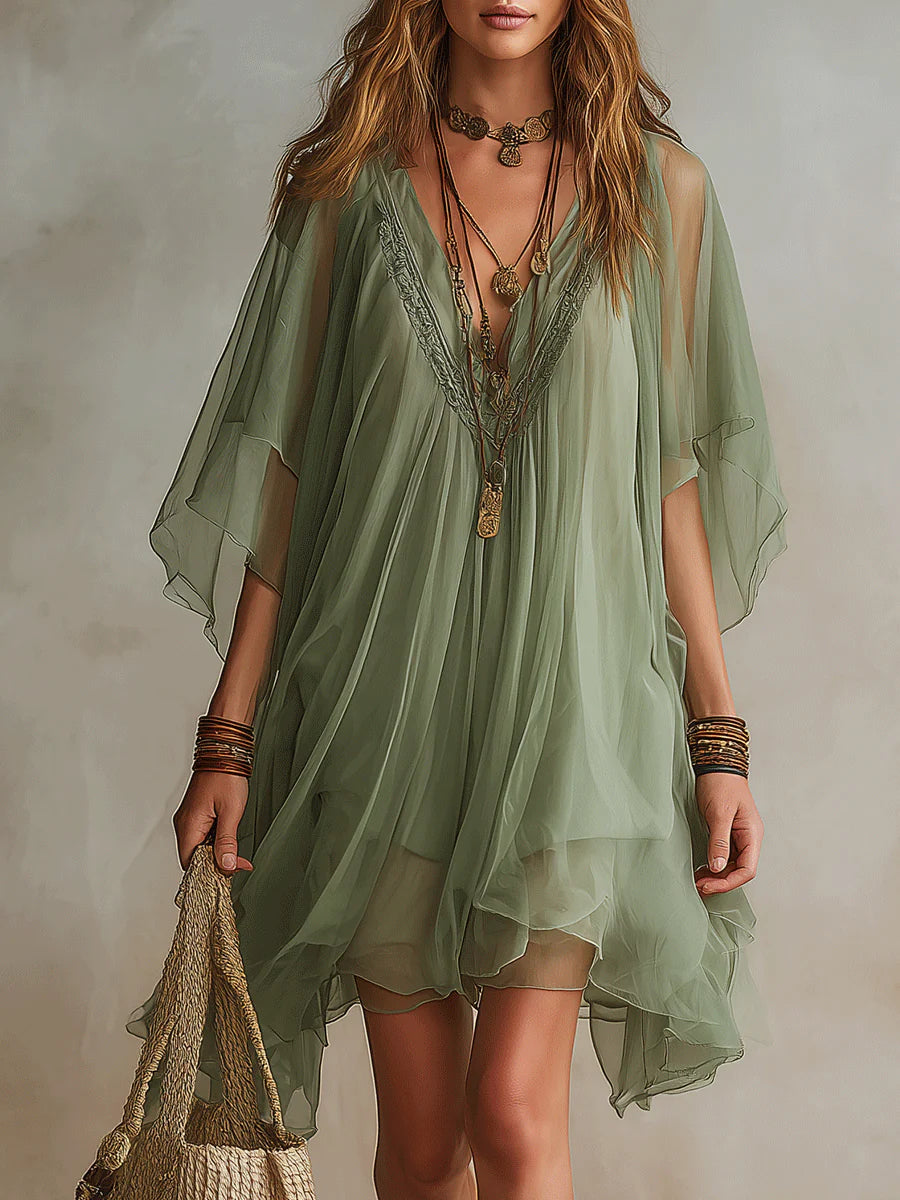 Effortless women's layered flowy green mini dress, perfect for a chic and comfortable summer look.