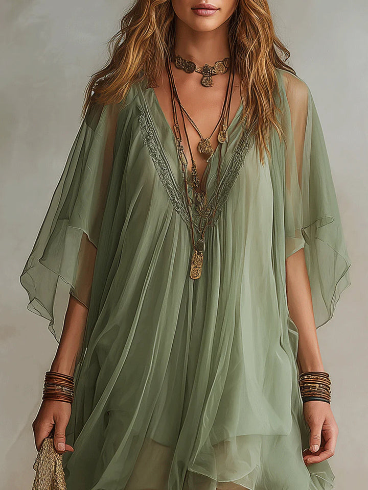 Green tiered mini dress for women, a flowy layered design offering a relaxed fit and effortless summer style.