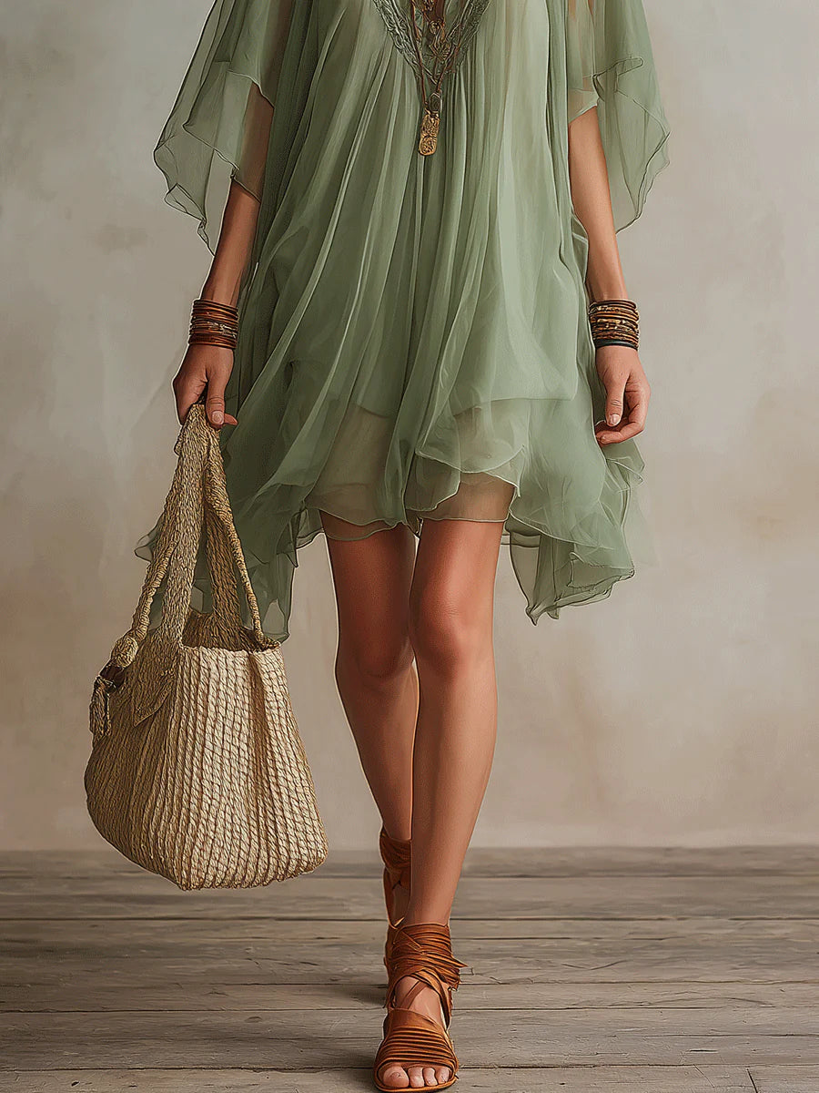 Stylish women's green mini dress, flowy and layered with a V-neck, ideal for summer casual and beachwear.