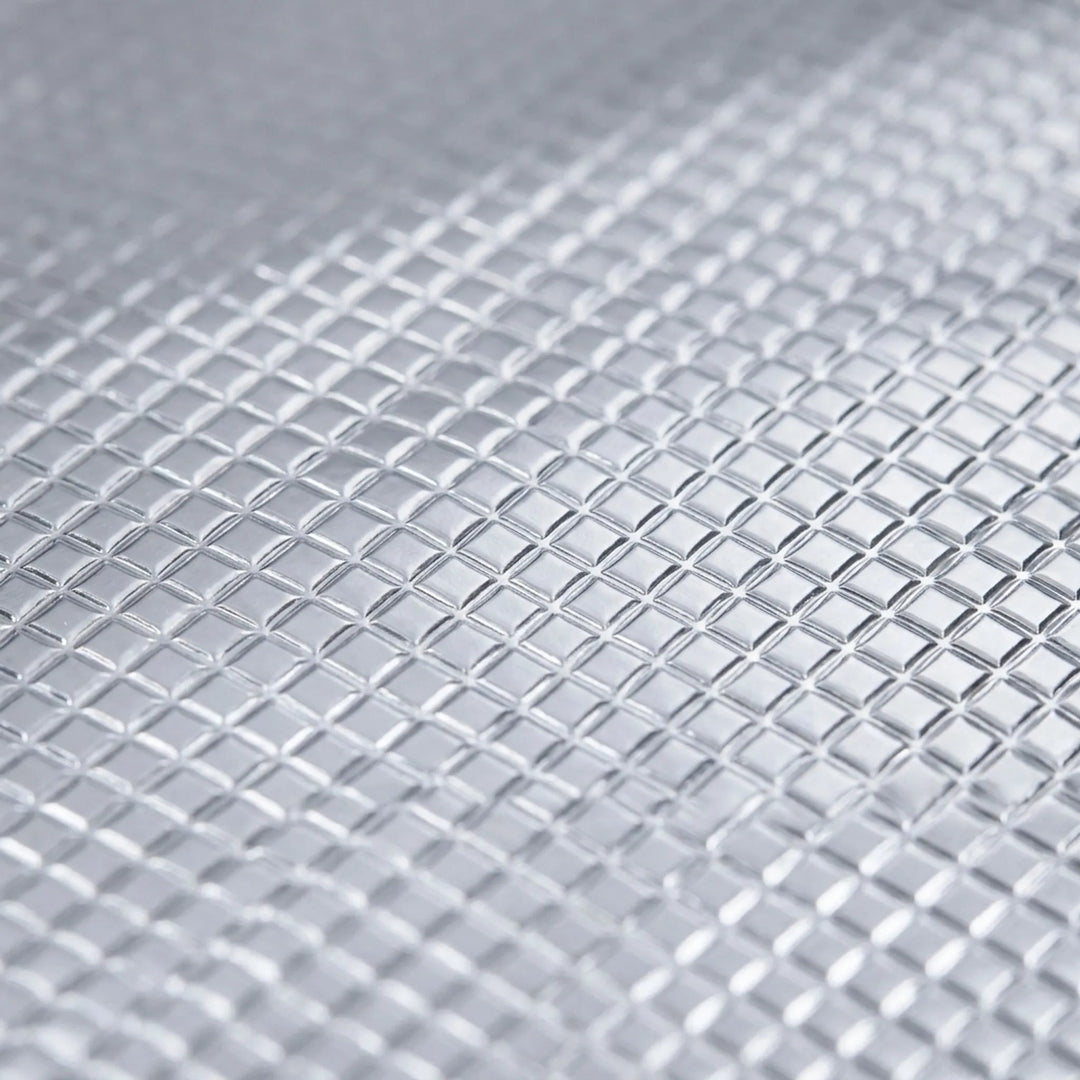 Reflective surface foldable camping mat for enhanced thermal insulation during outdoor adventures.