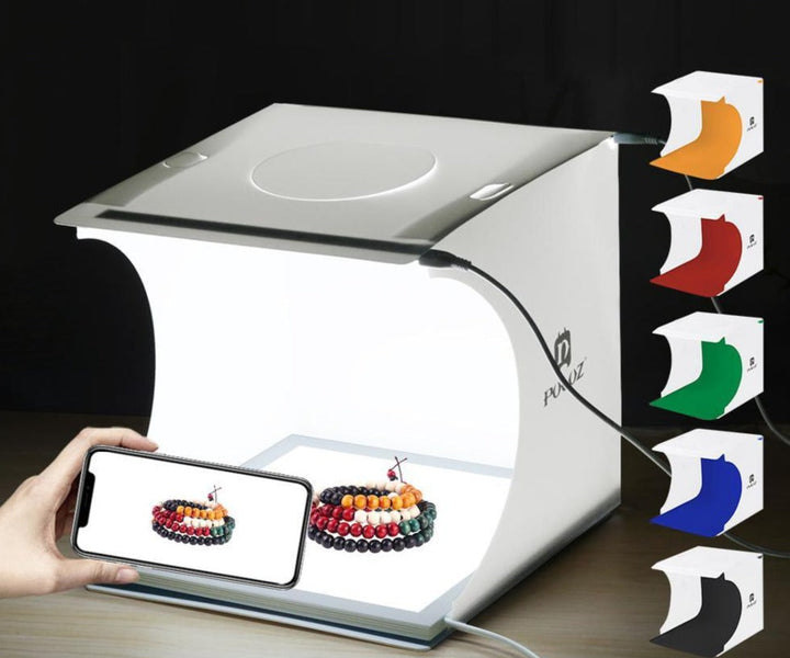 Compact foldable photo box with LED lighting & multiple backdrops, perfect for versatile product photography.