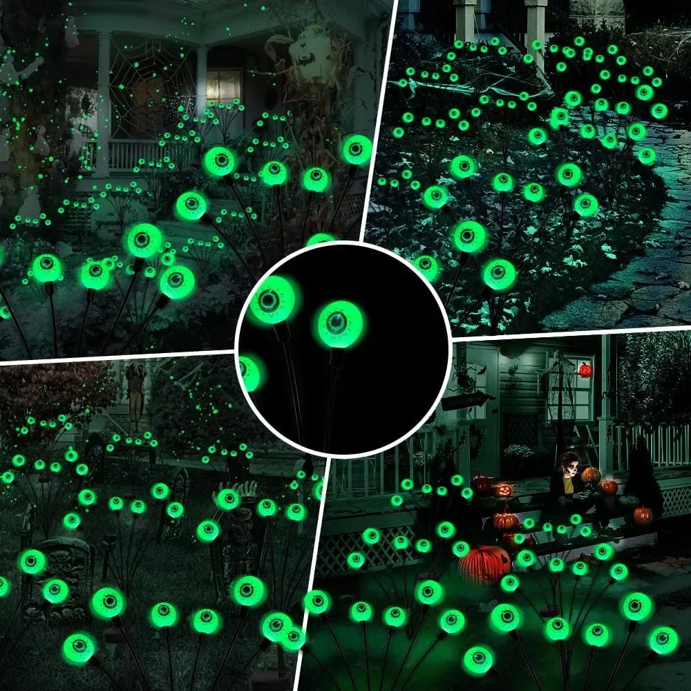 Four glowing eyeball lights, powered by solar, adding a spooky touch to a Halloween party