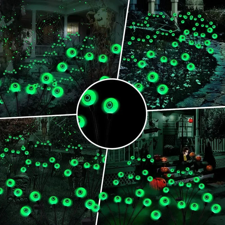 Four glowing eyeball lights, powered by solar, adding a spooky touch to a Halloween party