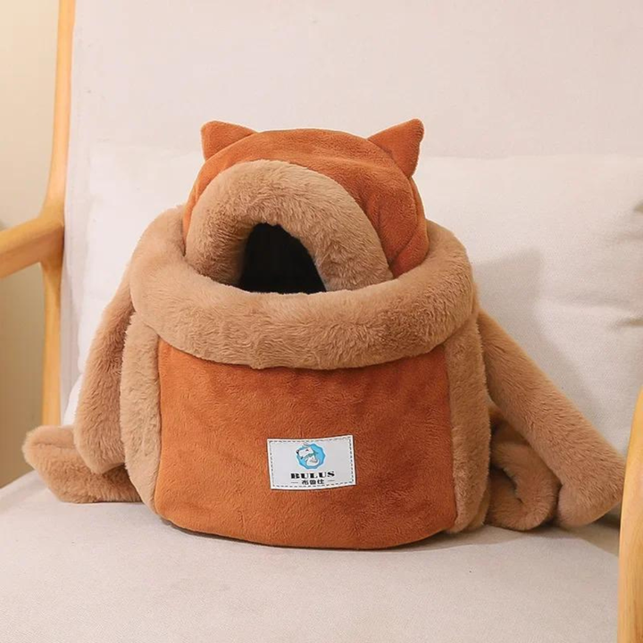 Side profile of a small brown dog comfortably inside New4 pet carrier backpack, outdoor travel gear