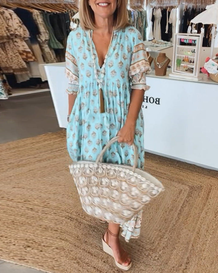 Front view of women's bohemian printed midi dress with lantern sleeves and V-neck, perfect for summer vacations.