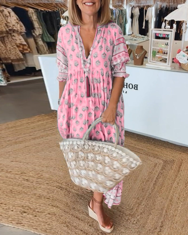 Midi length women's bohemian dress featuring a vibrant print and elegant lantern sleeves.