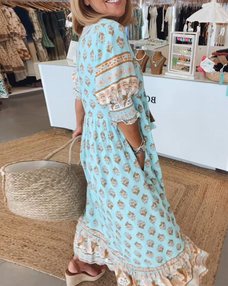 Close-up of the vibrant bohemian print on a women's flowy midi dress, featuring unique lantern sleeves.