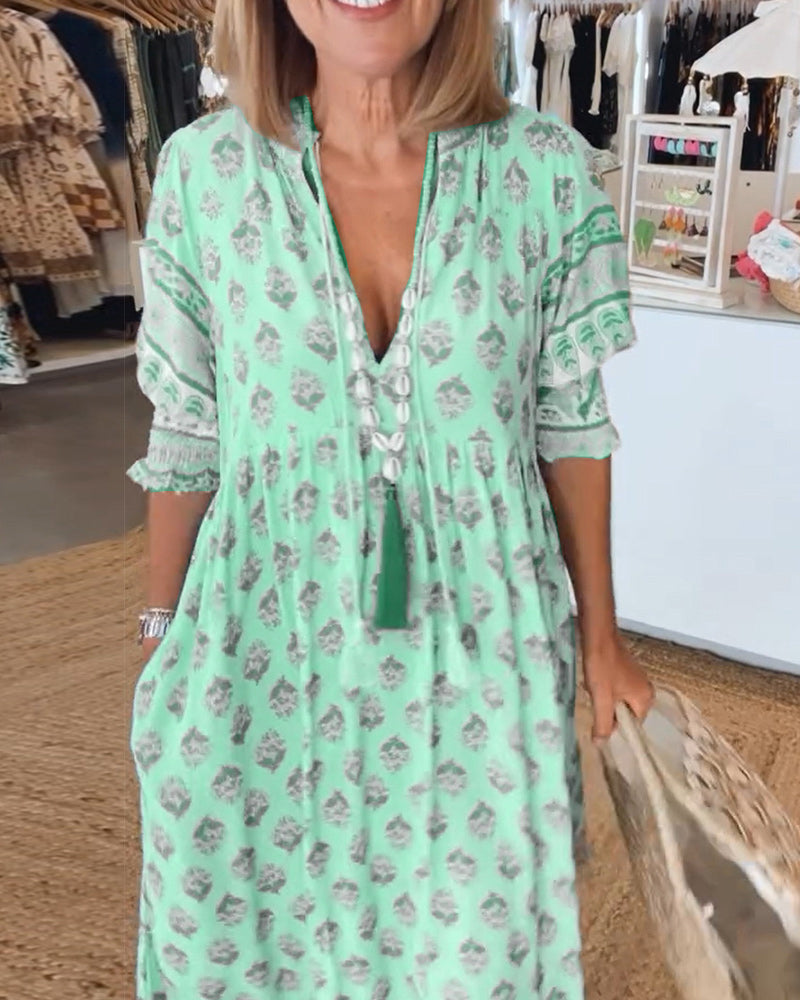 Side profile of a women's bohemian midi dress, highlighting its elegant drape and lantern sleeves.