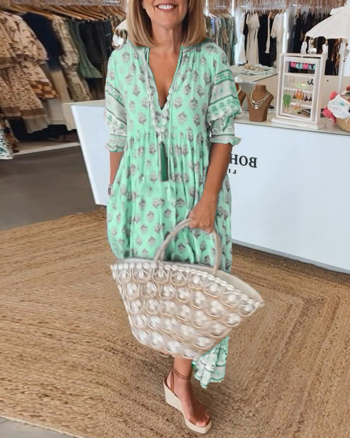 Detailed V-neckline of a women's printed bohemian midi dress, offering a flattering summer style.