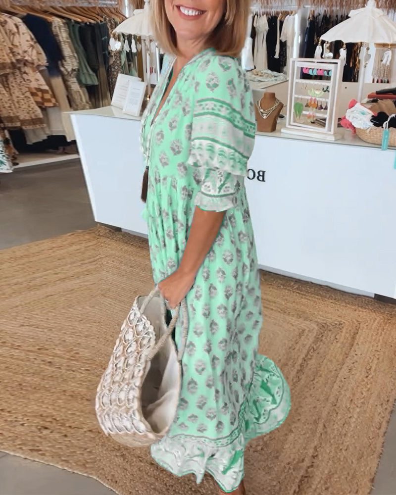 Women's bohemian printed midi dress with lantern sleeves, styled casually with sandals for summer.