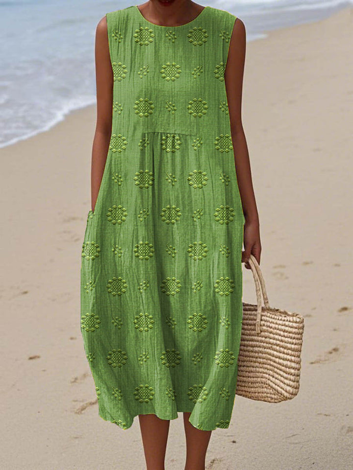 Front view of women's flowy summer midi dress in a vibrant color, featuring a comfortable sleeveless design & practical pockets.