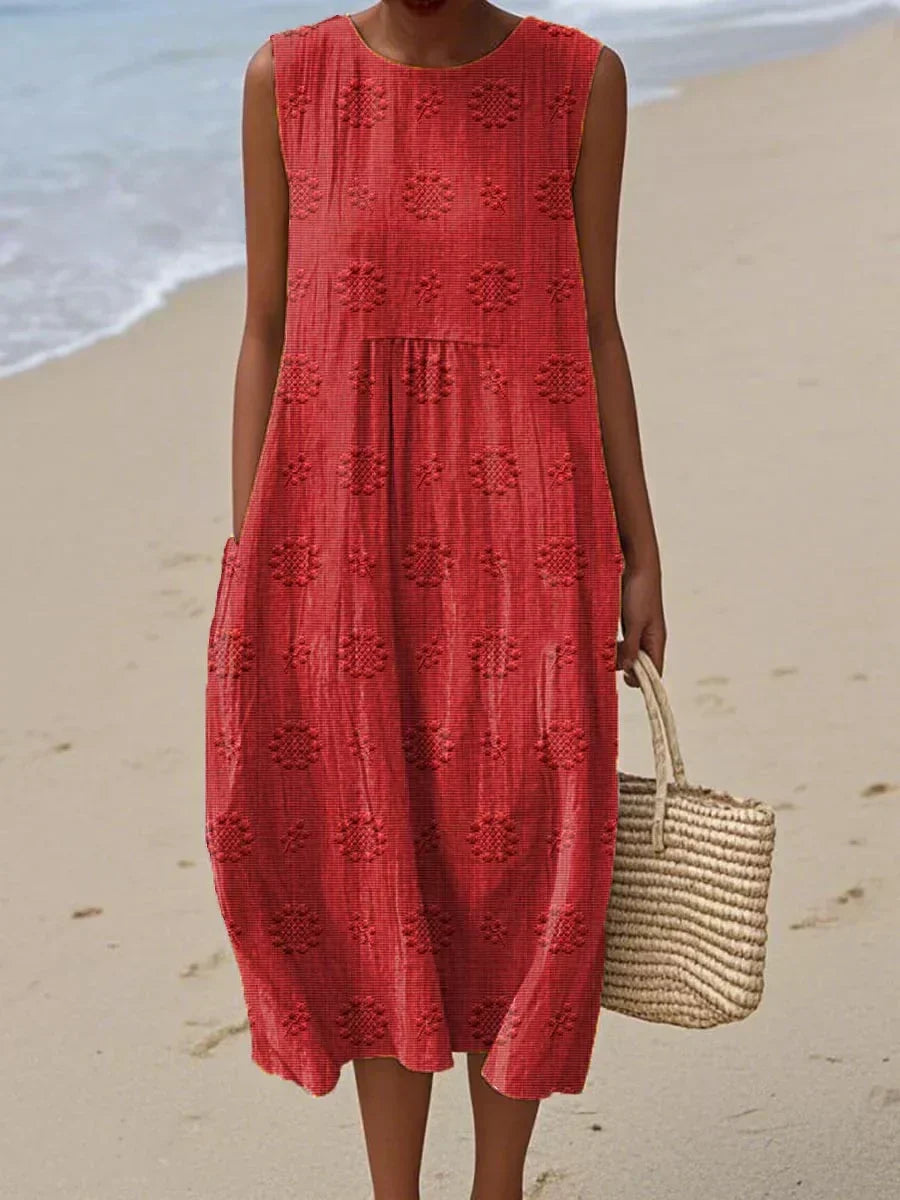 Detail of the breathable fabric of a women's summer midi dress, emphasizing its comfortable, flowy design with practical pockets.