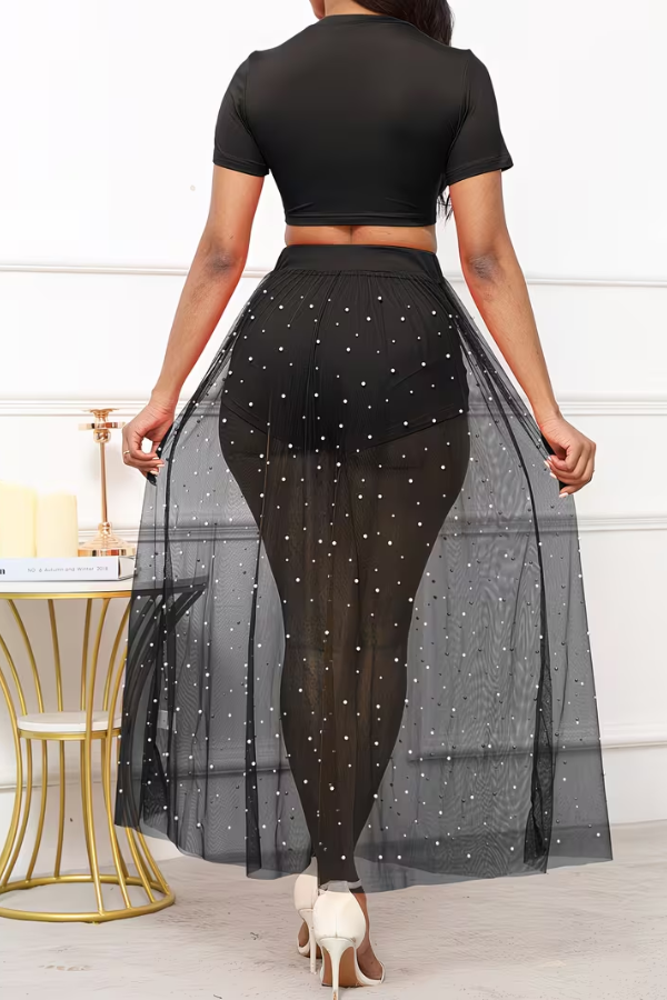 Fashionable women's summer vacation outfit: an elegant matching croptop, skirt & flowing outer layer.