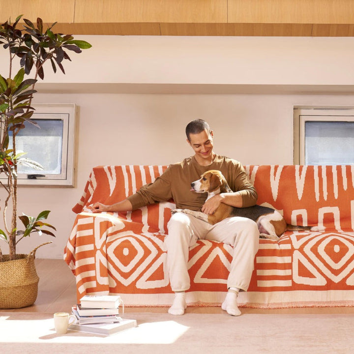 Geometric boho sofa cover in a living room protecting furniture from pets