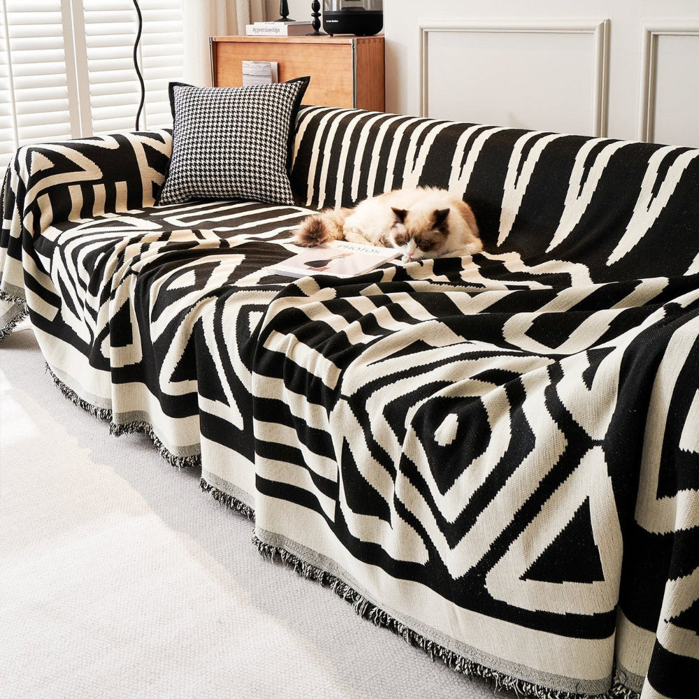 Boho sofa cover with a modern geometric pattern draped over a living room couch