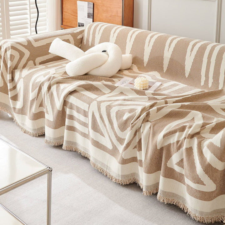 Stylish pet-friendly geometric boho throw blanket on a sofa, vibrant home decor