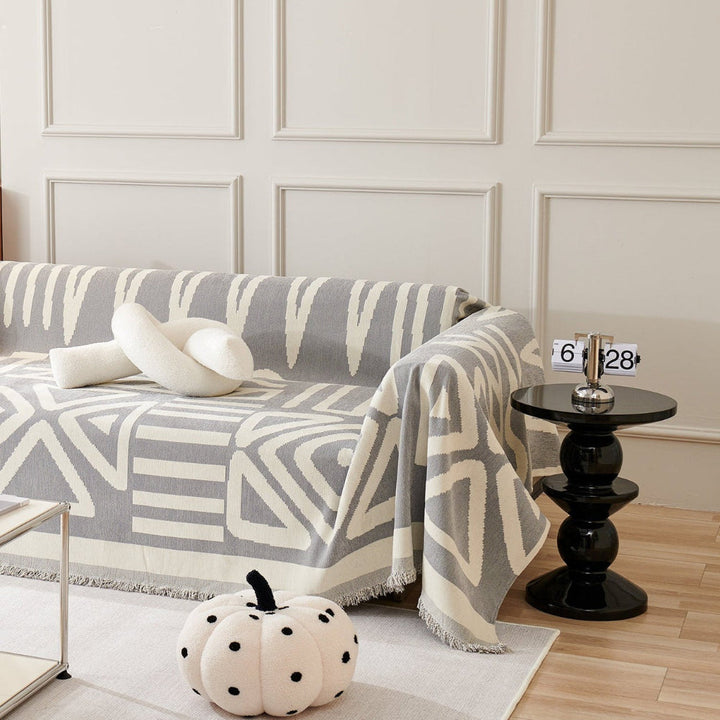 Detailed view of a geometric and boho-inspired couch cover for modern homes