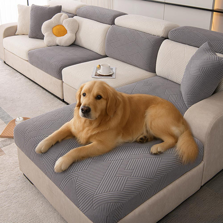 Geometric jacquard stretch sofa cover in a living room, protecting furniture from pets.