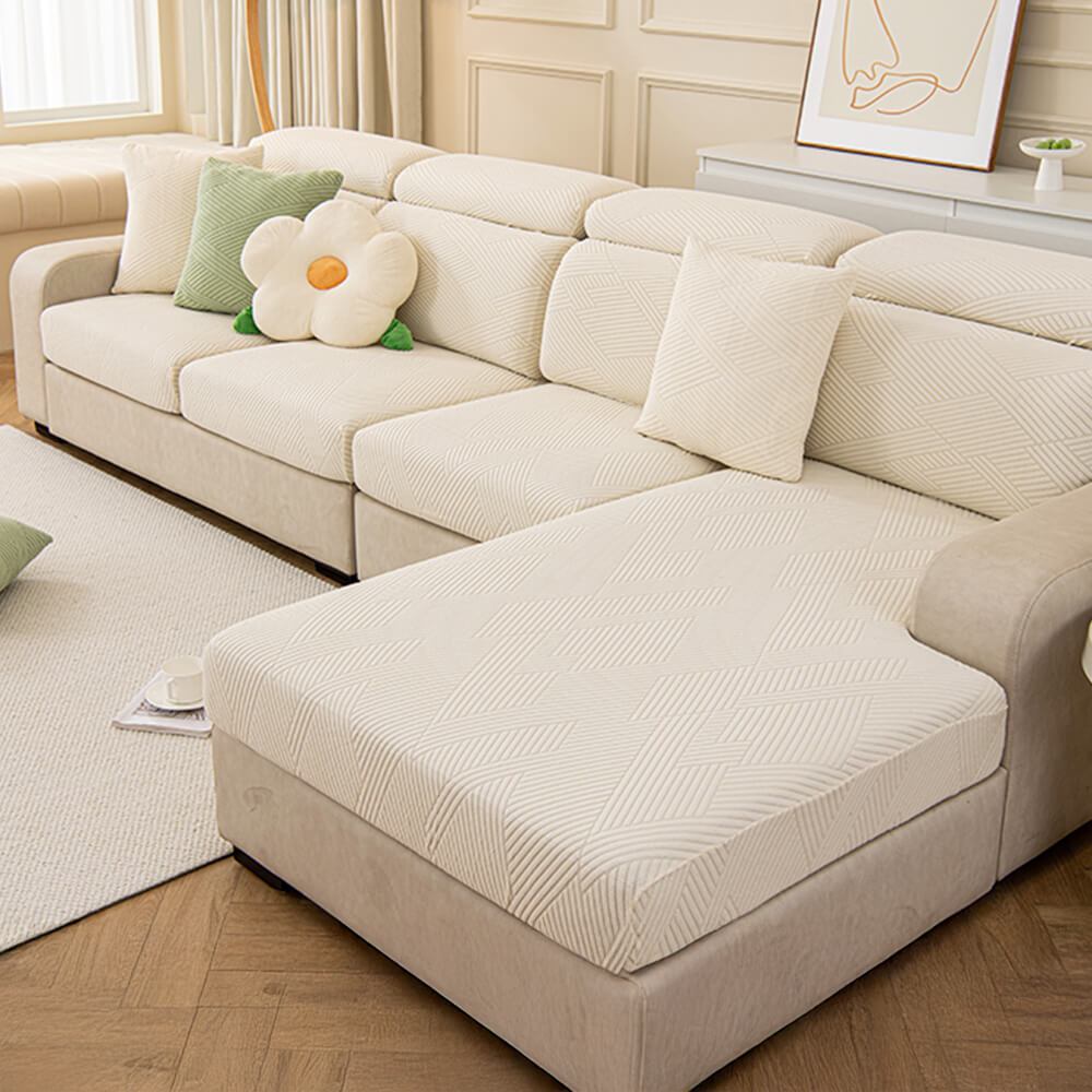 Detail of the durable fabric of a geometric jacquard stretch sofa cover, pet-friendly and resilient.
