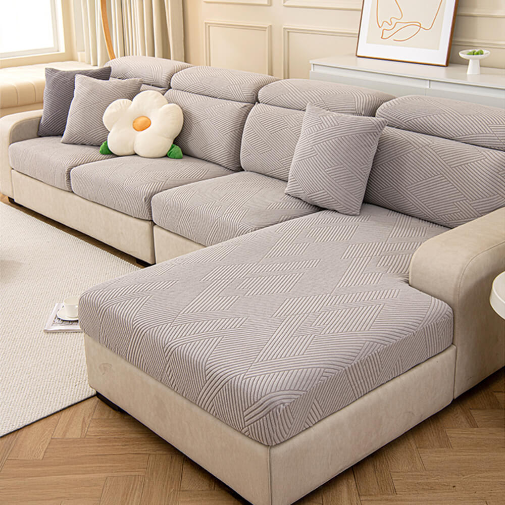 Modern geometric jacquard design on a stretch couch cover, perfect for homes with pets.