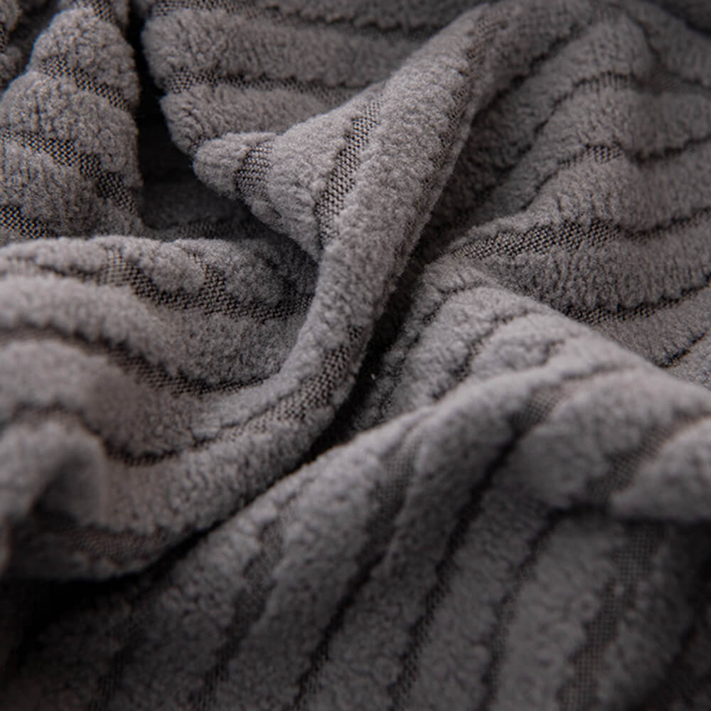 Dark grey geometric jacquard stretch sofa cover, durable and pet-friendly furniture protection.