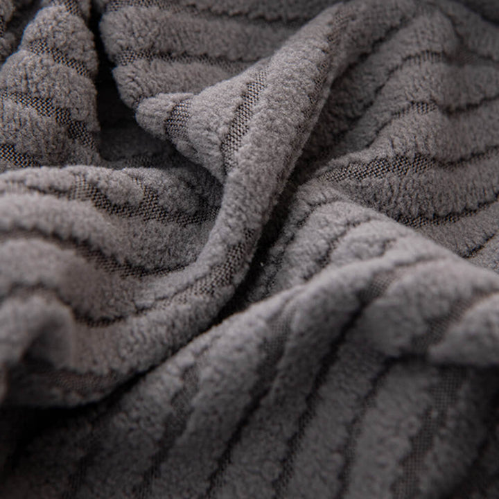Dark grey geometric jacquard stretch sofa cover, durable and pet-friendly furniture protection.
