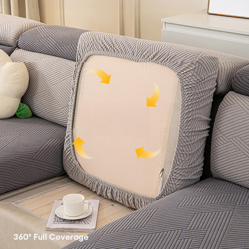 Light beige geometric jacquard stretch couch cover, stylish and pet-proof living room decor.