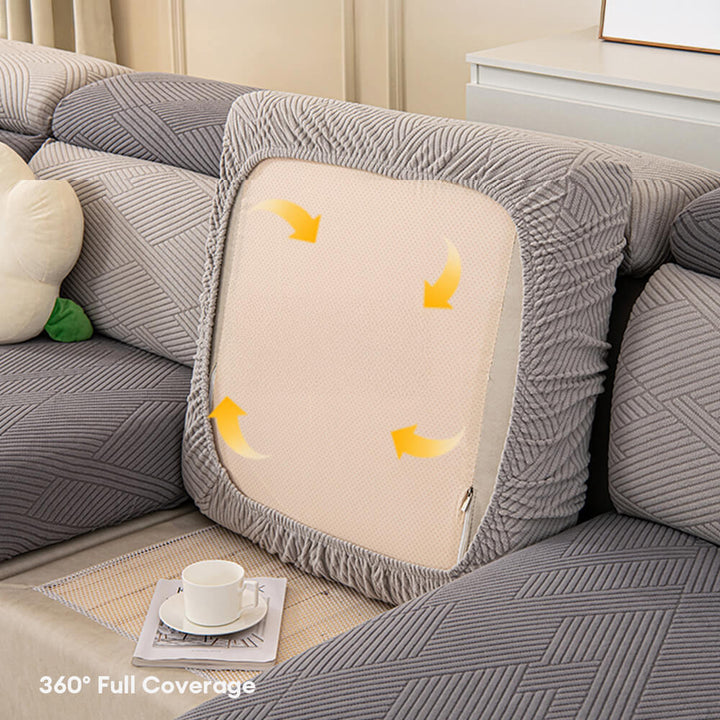 Light beige geometric jacquard stretch couch cover, stylish and pet-proof living room decor.