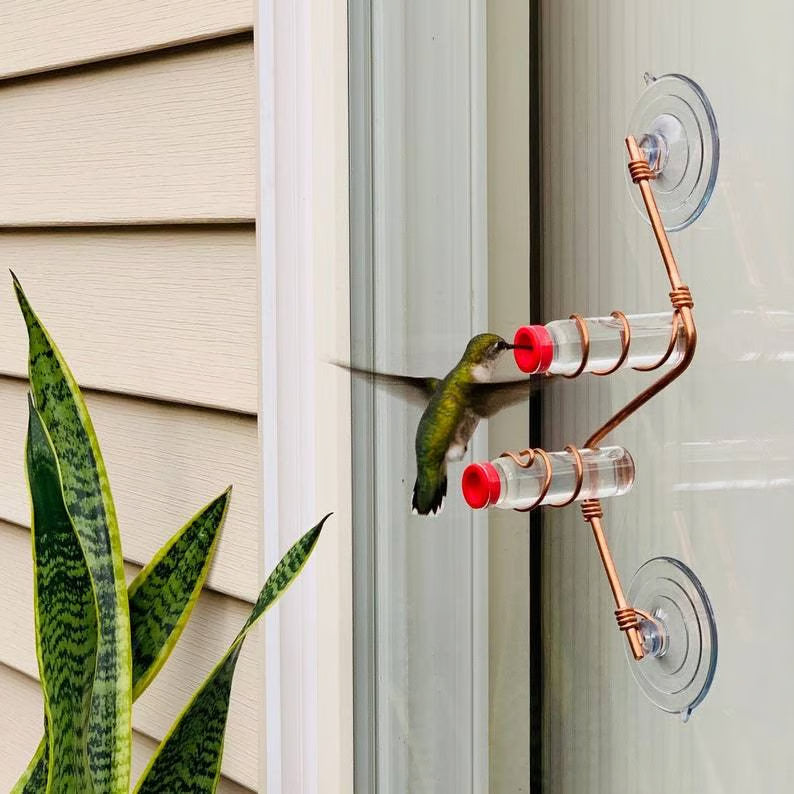 Window mounted geometric hummingbird feeder, clear view of design and bird access for outdoor decor.