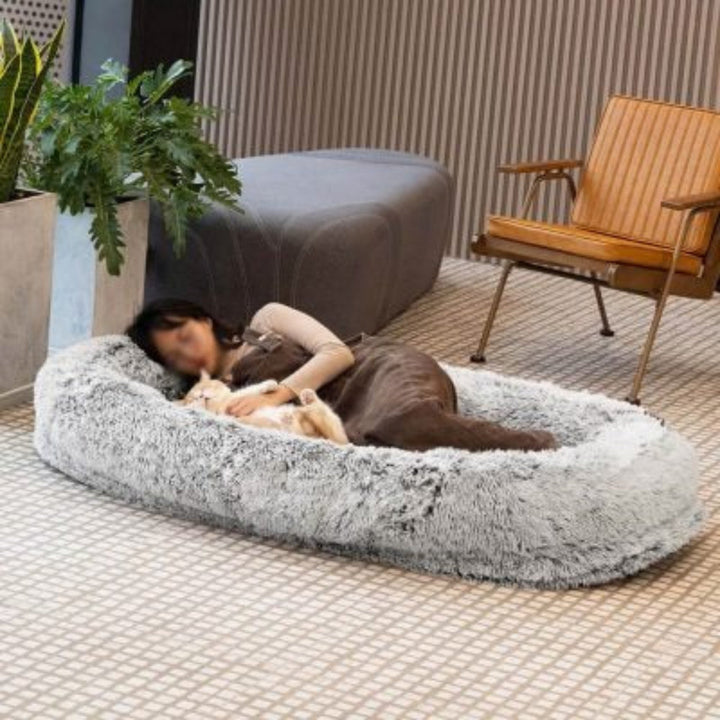 Oversized pet bed for humans & pets, featuring an anxiety-relief design and washable faux fur cover