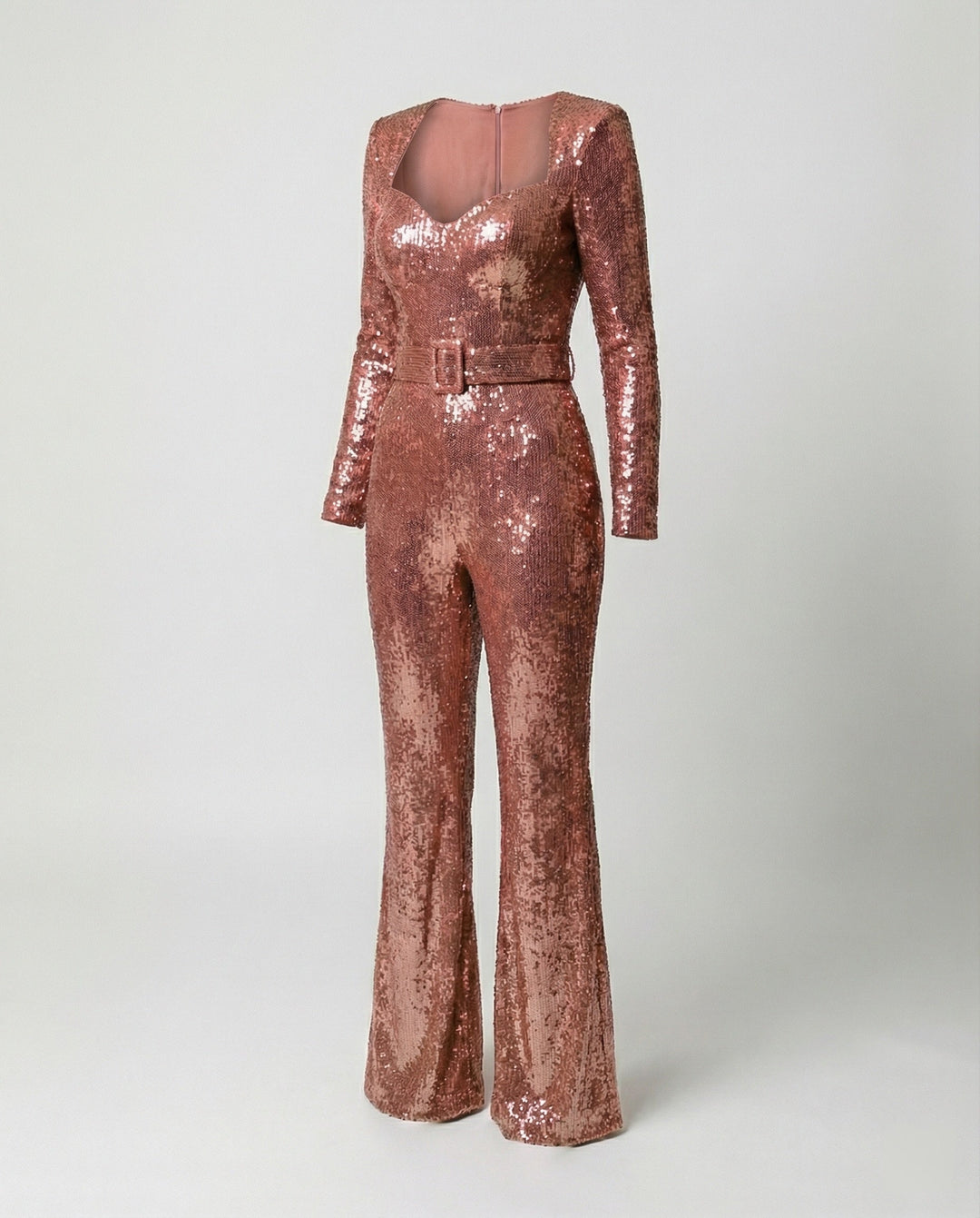 Close-up of a women's glamorous sequin jumpsuit, showcasing sparkle & elegant design. Perfect for evening & special events.