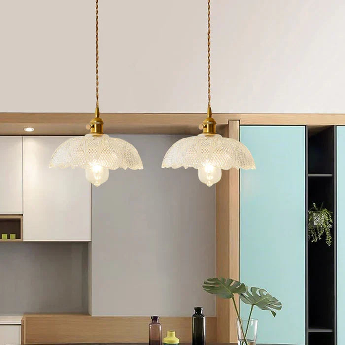 Elegant glass pendant light, perfect for illuminating a dining table in modern homes.