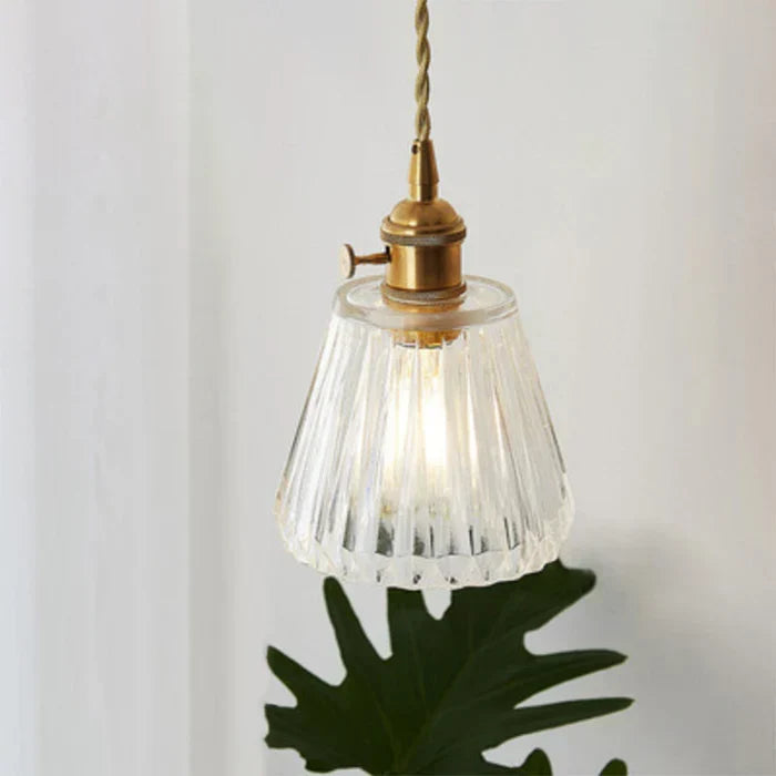 Transparent glass pendant lamp, providing ambient light for elegant dining.