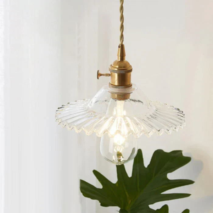 Clear glass pendant light, perfect for illuminating dining spaces and home decor.