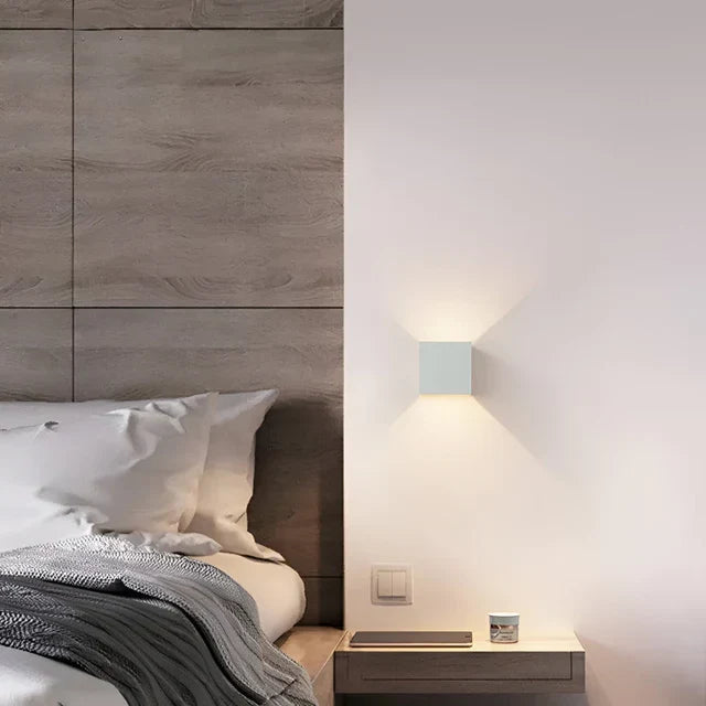 Sleek black modern motion sensor LED wall light for indoor/outdoor use, offering accent & security lighting.
