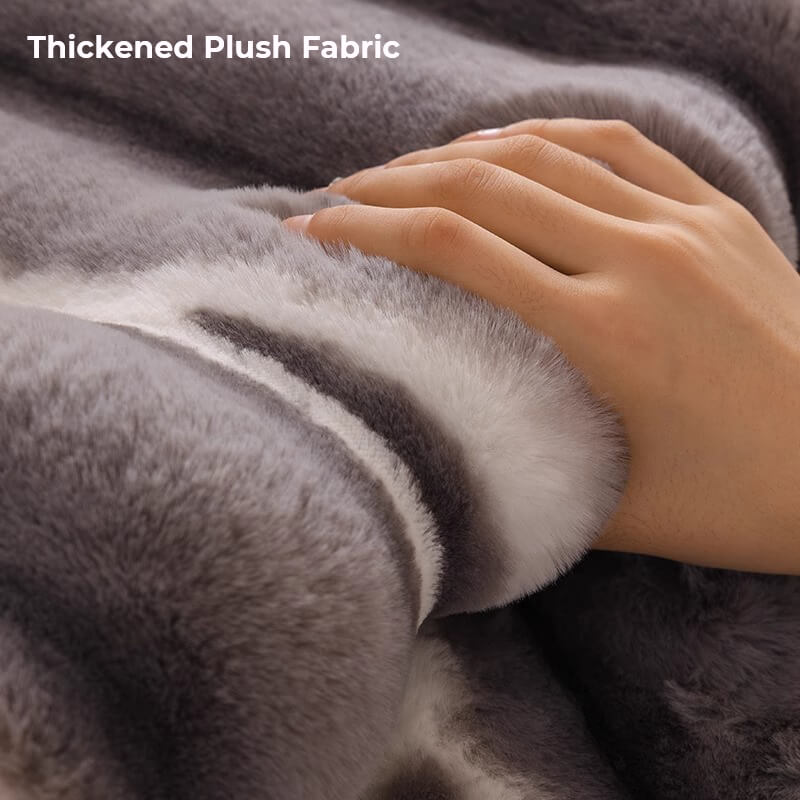 Reversible Gradient Stripe Plush Sofa Protector on a brown couch, showing non-slip backing