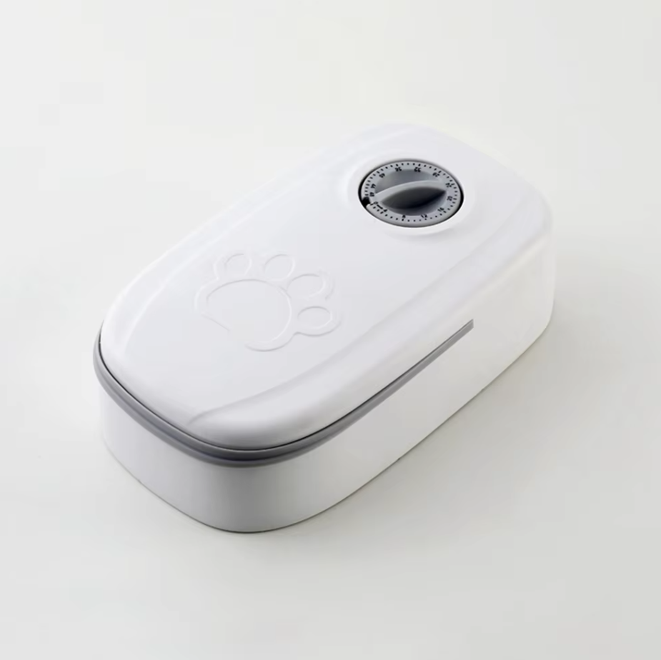 Pet supplies: gray automatic feeder with timer for precise dog and cat food delivery.