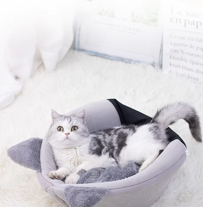 Cat supplies: black cat-shaped pet bed featuring a comfortable, removable cushion.