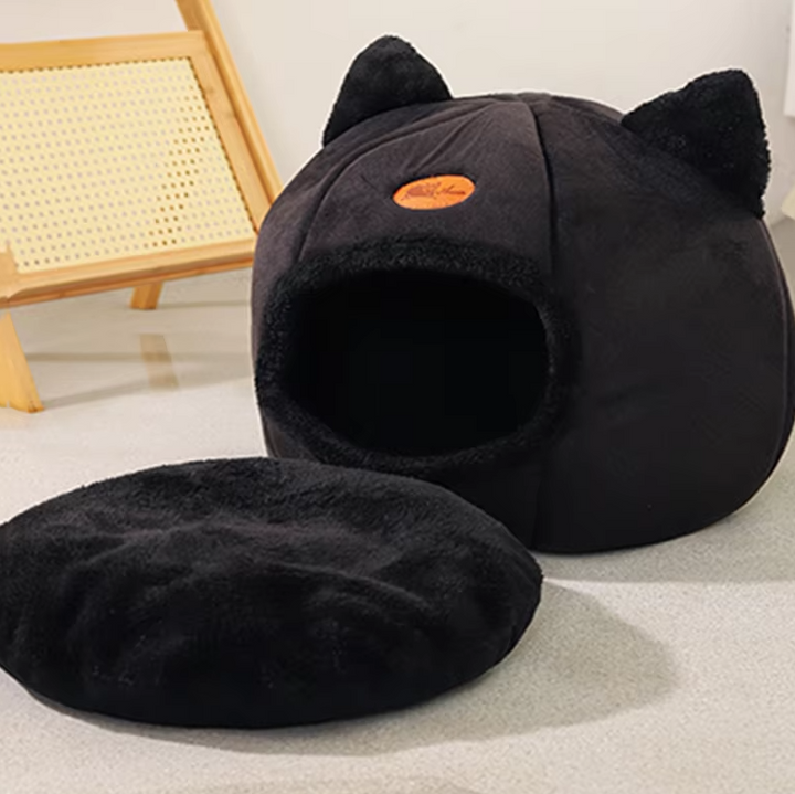 Warming cat bed, black cat-shaped, with a soft removable cushion for cozy naps.